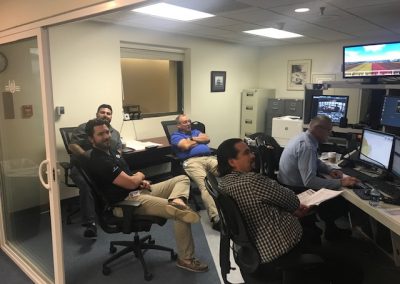 Men sitting and watching a simulation