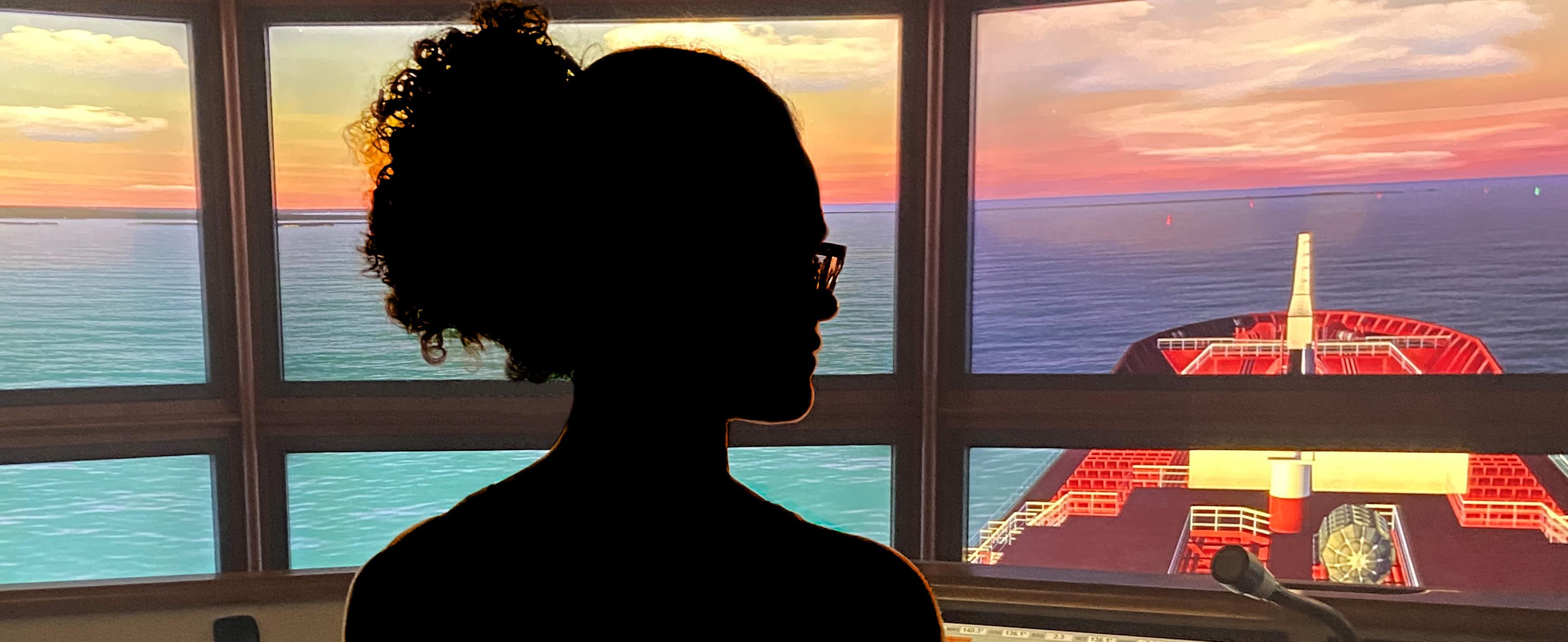 Silhouette of female mariner on the bridge