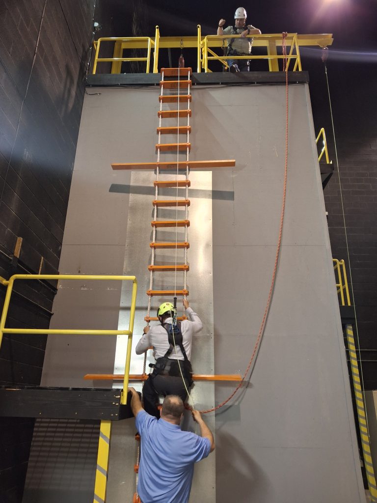 Maritime pilot practicing ladder climb at 7 meters on MITAGS training tower.